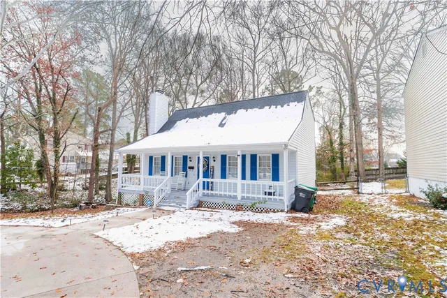 a front view of a house with a yard covered in snow