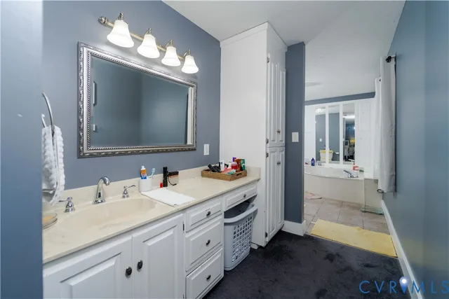 a bathroom with double vanity and a mirror