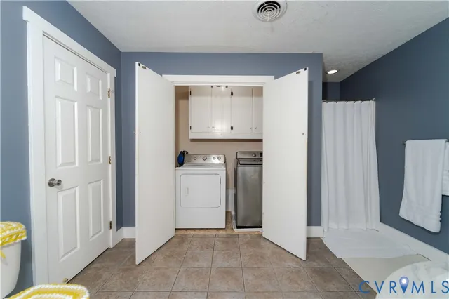 a view of a hallway with bathroom and wooden floor