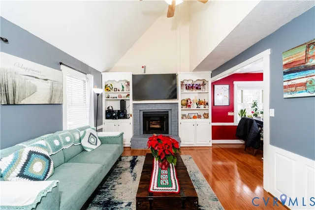 a living room with furniture a flat screen tv and a fireplace