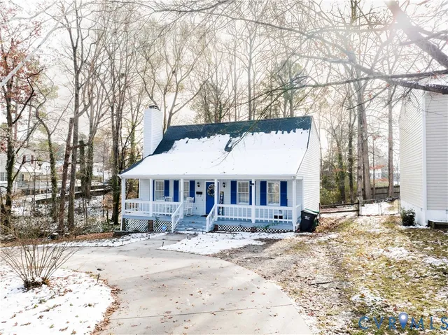 a front view of a house with a yard covered in snow