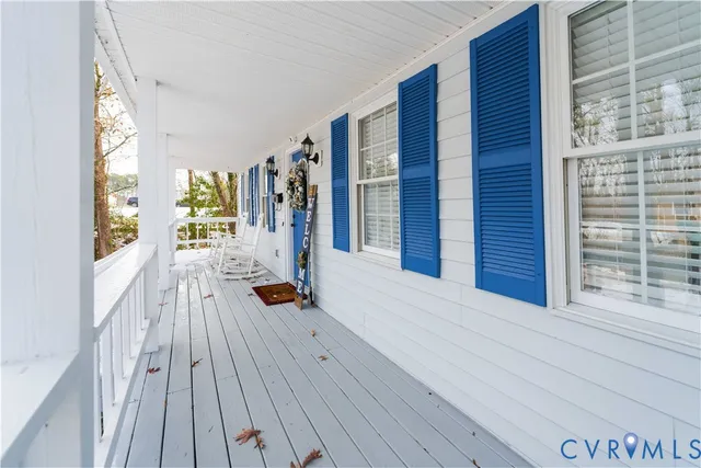 a bedroom with furniture and large windows