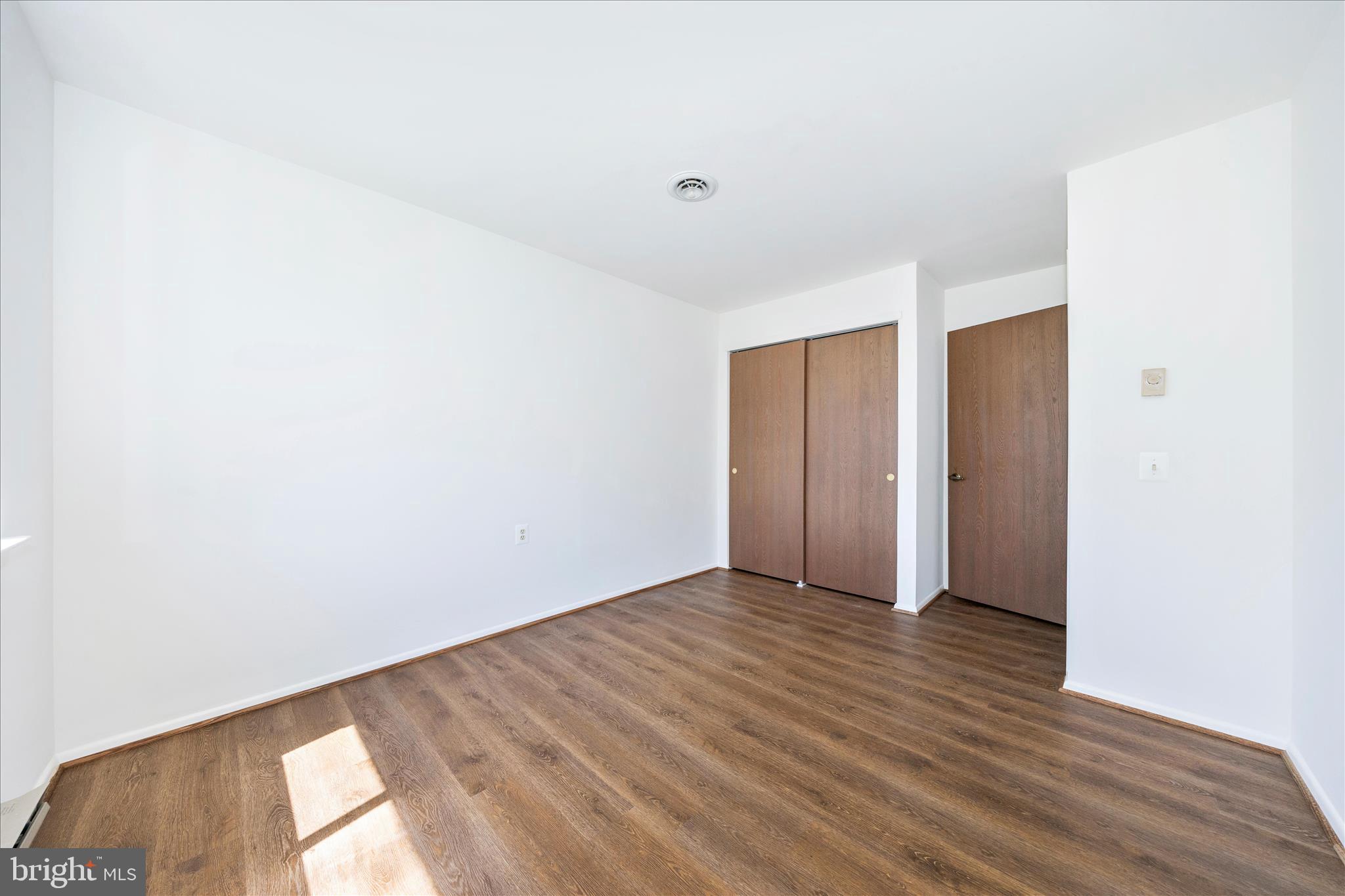 5738 Box Elder Court Frederick, MD 21703 - Photo 24 of 50 a view of an empty room with wooden floor