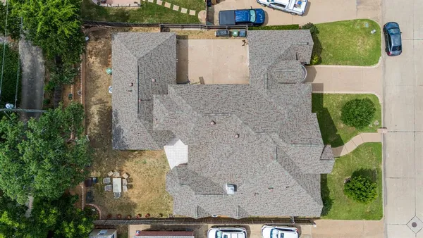 an aerial view of residential houses with outdoor space
