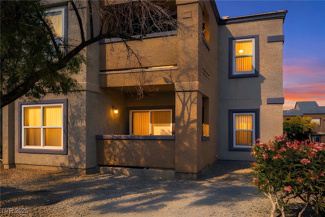 Rear view of property with stucco siding