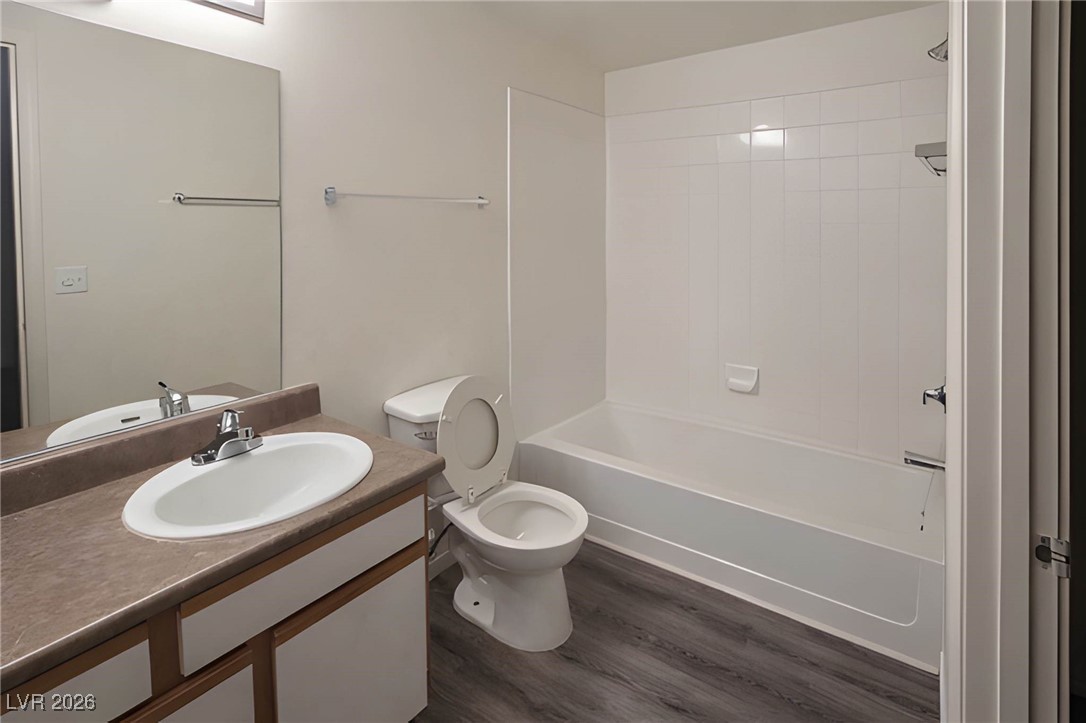 6650 West Warm Springs Road, Unit 1064 Las Vegas, NV 89118 - Photo 6 of 10 Bathroom with vanity, washtub / shower combination, and dark wood-type flooring
