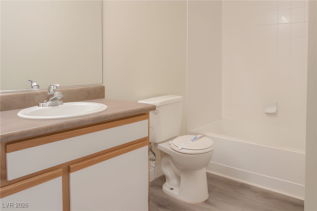 6650 West Warm Springs Road, Unit 1064 Las Vegas, NV 89118 - Photo 9 of 10 Bathroom with vanity, light wood-type flooring, and shower / tub combination