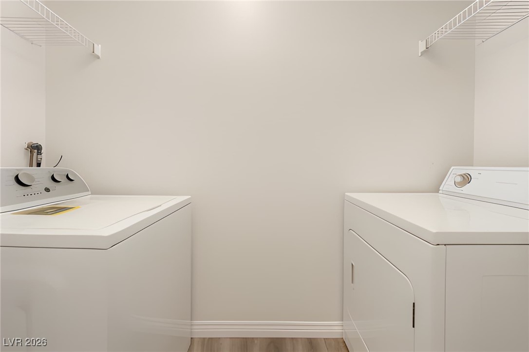 6650 West Warm Springs Road, Unit 1064 Las Vegas, NV 89118 - Photo 10 of 10 Laundry room featuring light wood finished floors and washer and clothes dryer