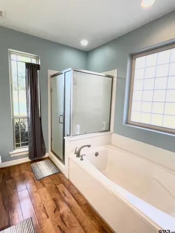 a bathroom with a bathtub and a shower