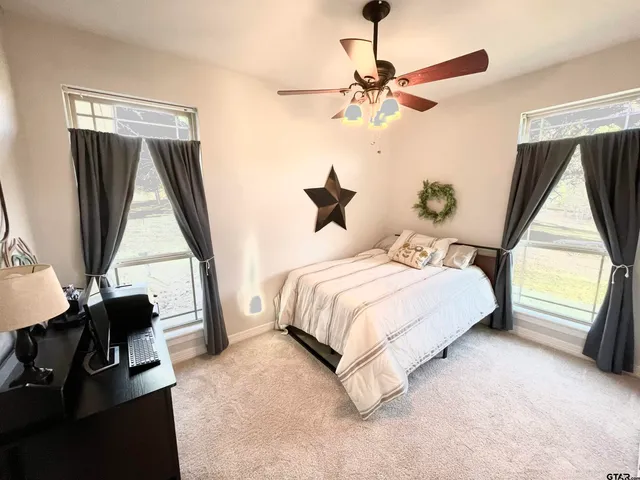 a bedroom with a bed and a flat tv screen