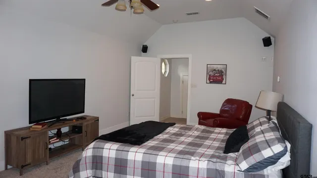 a bedroom with a bed and a flat screen tv