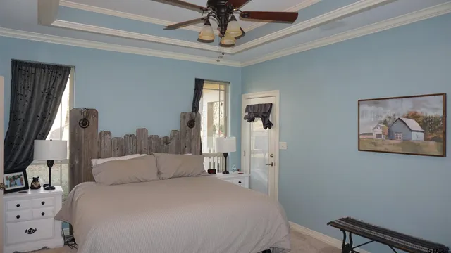 a bedroom with a bed and a chandelier