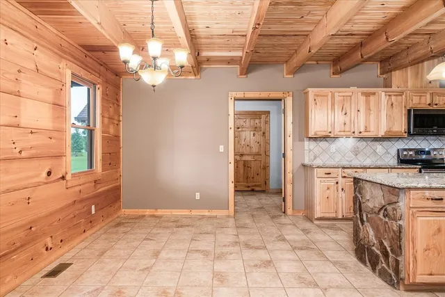 a kitchen with granite countertop a sink and white cabinets