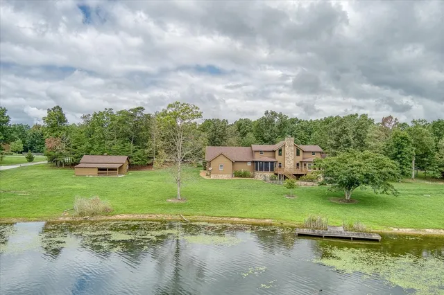 a house with green field in front of it