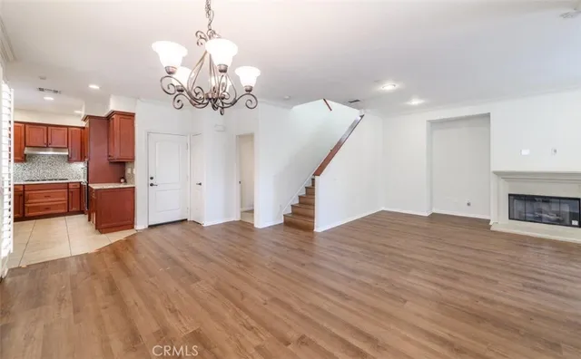 a kitchen with stainless steel appliances kitchen island granite countertop a refrigerator and a sink