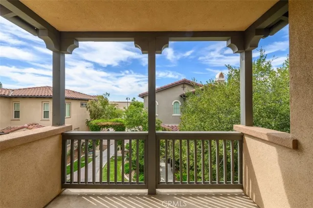 an empty room with wooden floor fireplace and windows