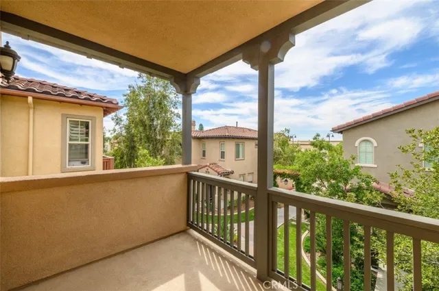 an empty room with wooden floor fireplace and windows