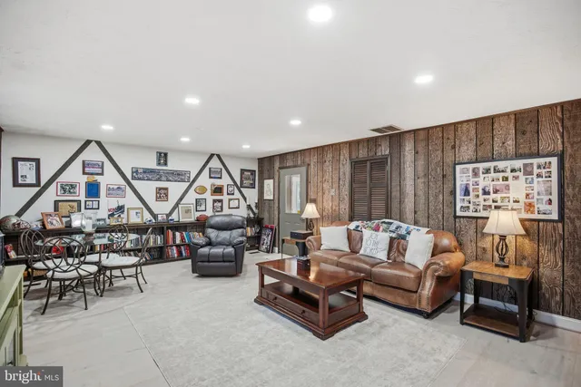 a dining room with furniture a chandelier and wooden floor