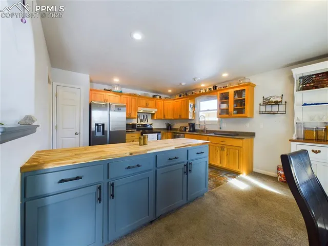 a kitchen with stainless steel appliances granite countertop a sink stove and cabinets