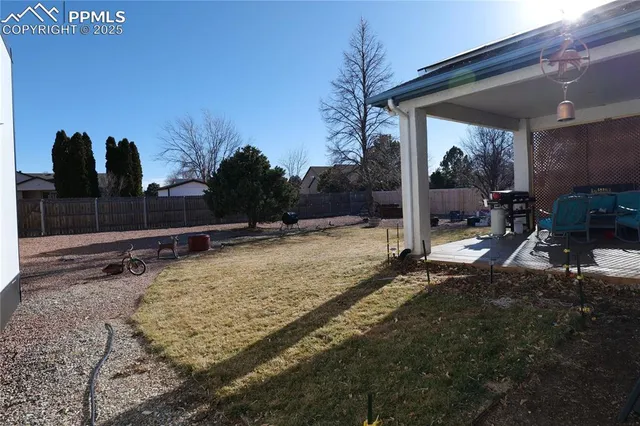 a view of house with yard in front of it