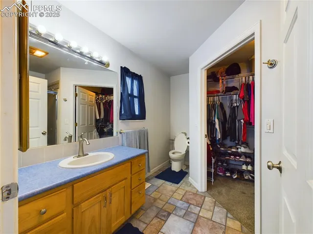a bathroom with a sink a toilet and a mirror
