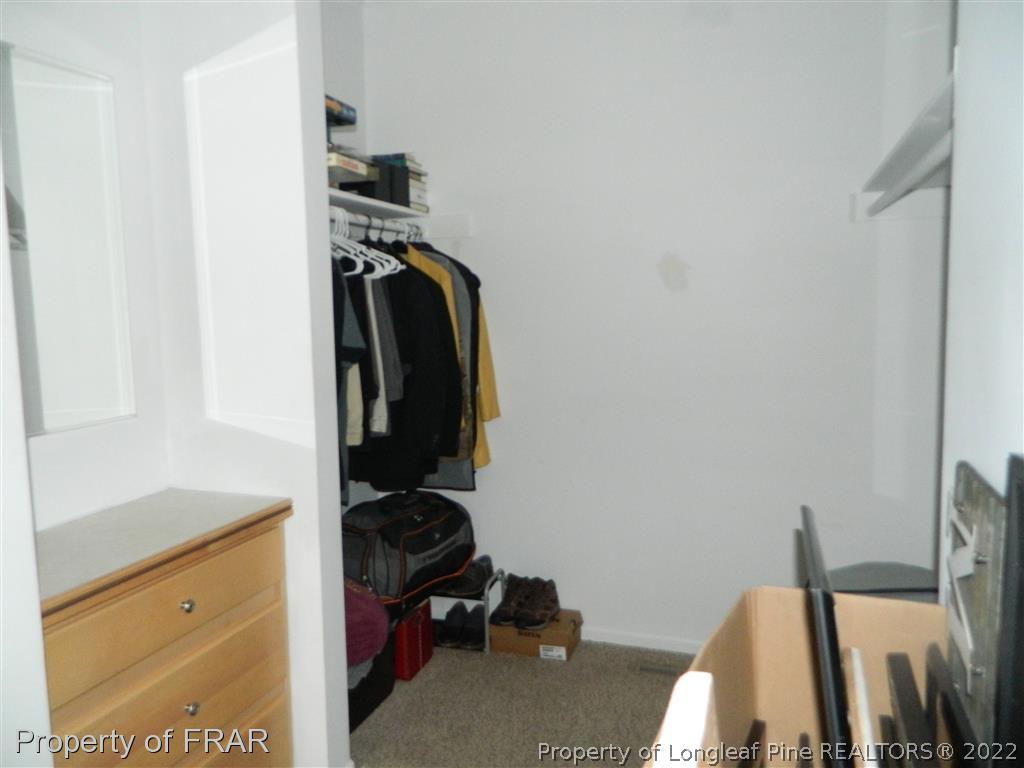 50 Cutoff Road Dunn, NC 28334 - Photo 13 of 33 a view of walk in closet with clothes and shoes