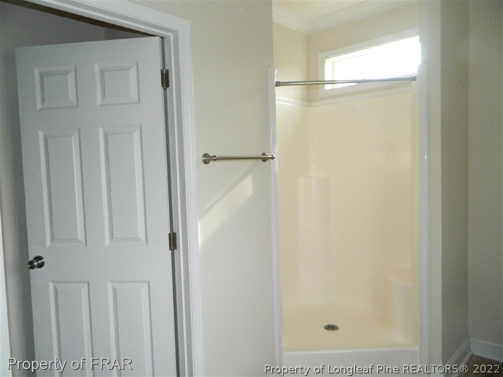 50 Cutoff Road Dunn, NC 28334 - Photo 17 of 33 a bathroom with a glass shower door
