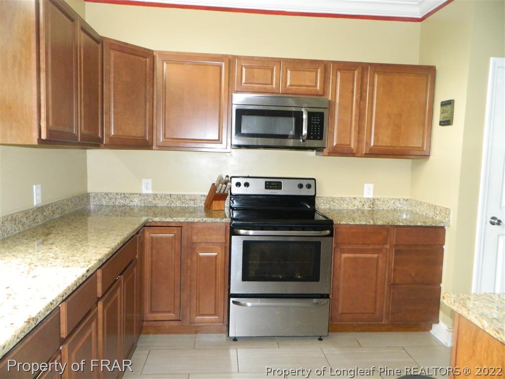 50 Cutoff Road Dunn, NC 28334 - Photo 8 of 33 a kitchen with stainless steel appliances granite countertop a sink stove and microwave
