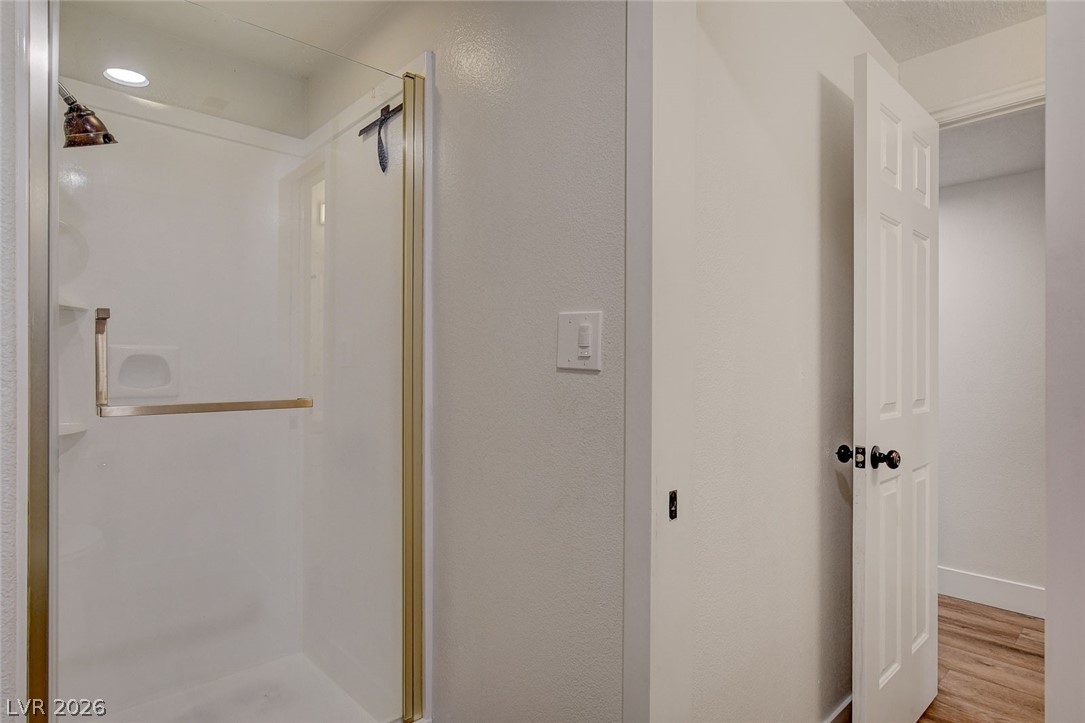 4362 Thistle Street Logandale, NV 89021 - Photo 55 of 99 A pristine shower stall with sleek glass and bronze trim, ready for rejuvenation.