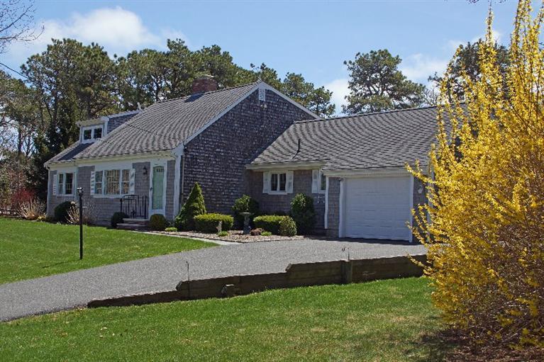 a front view of a house with a yard and porch