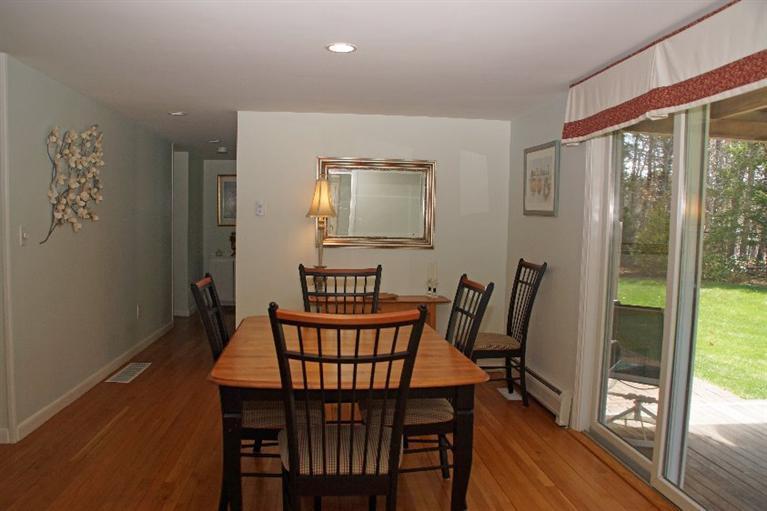29 Jesse Eldredge Road Harwich, MA 02645 - Photo 11 of 25 a view of a dining room with furniture wooden floor and a floor to ceiling window