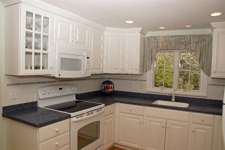 29 Jesse Eldredge Road Harwich, MA 02645 - Photo 13 of 25 a kitchen with granite countertop white cabinets and a sink