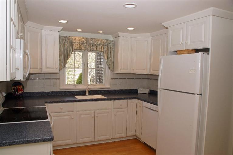 29 Jesse Eldredge Road Harwich, MA 02645 - Photo 14 of 25 a kitchen with a sink a refrigerator and cabinets
