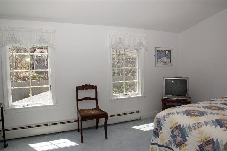 29 Jesse Eldredge Road Harwich, MA 02645 - Photo 18 of 25 a bedroom with a bed and a window