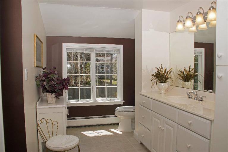 29 Jesse Eldredge Road Harwich, MA 02645 - Photo 20 of 25 a bathroom with a toilet sink and mirror