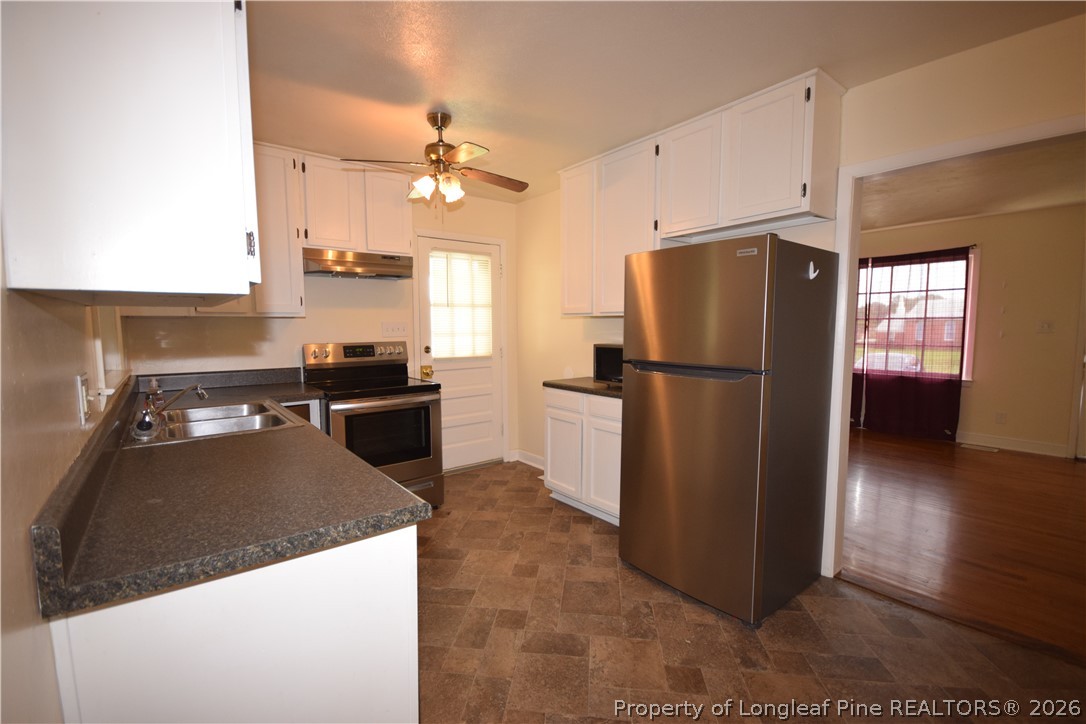 108 South 6th Street Spring Lake, NC 28390 - Photo 10 of 20 a kitchen with stainless steel appliances granite countertop a refrigerator a sink a stove and a refrigerator
