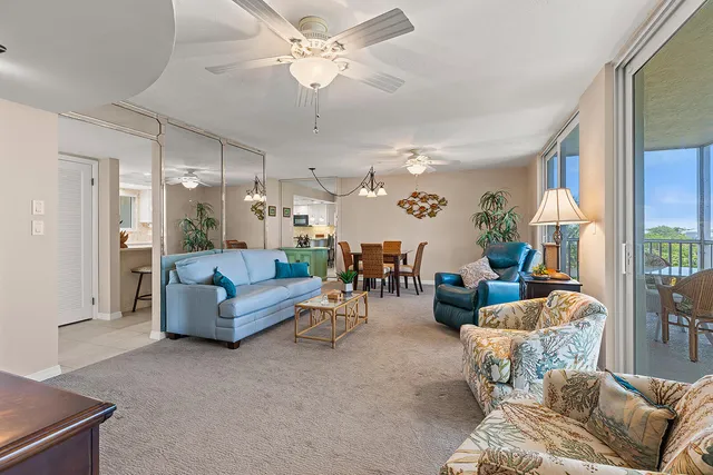 a living room with furniture and a chandelier