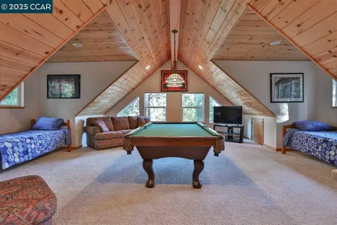 a living room with furniture and a ceiling fan