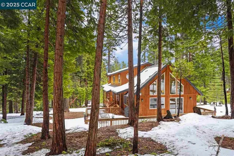 a view of a house with a yard and garage