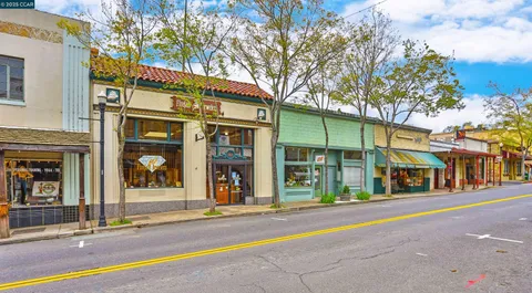 a view of a lush green hillside and mountains