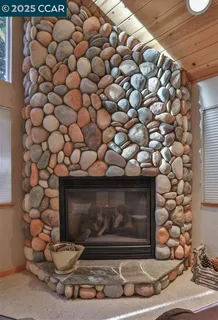 a room with a wooden floor and a fireplace