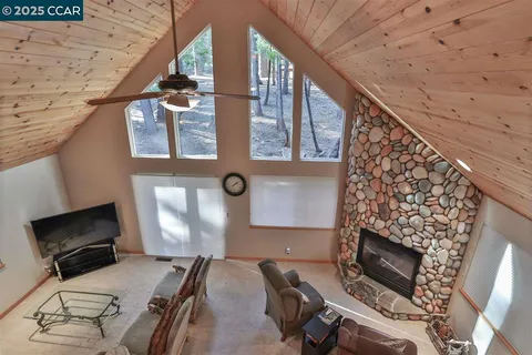 a balcony with furniture and a fireplace