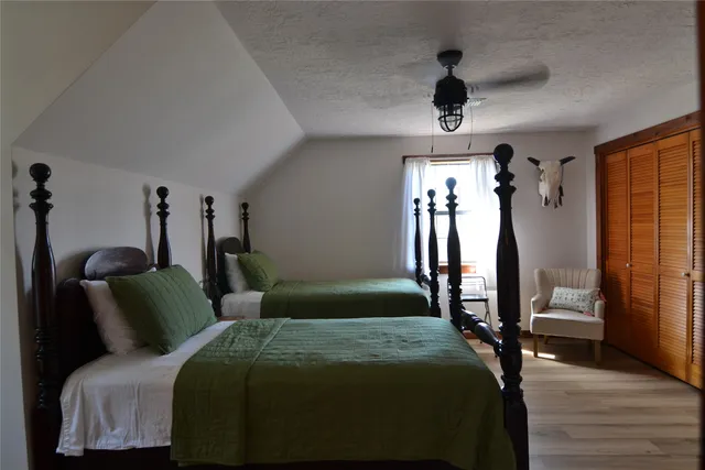 a bedroom with a bed and a chandelier