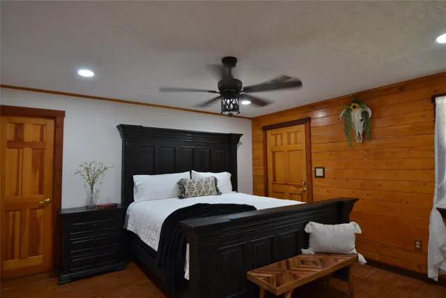 a bedroom with a bed and a chandelier