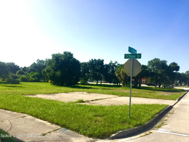 a swimming pool with lots of green space and plants