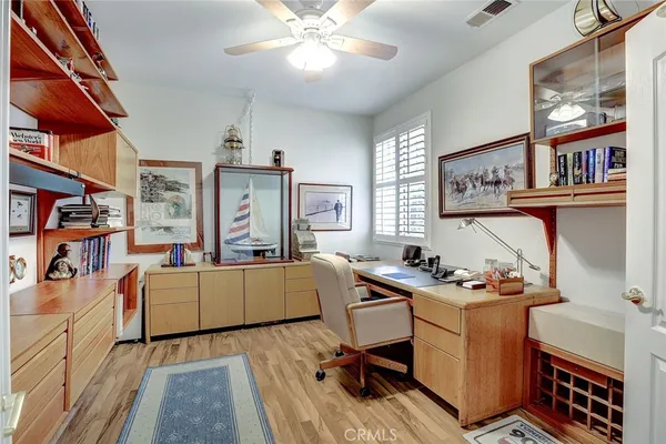 a room with furniture a bookshelf and a window