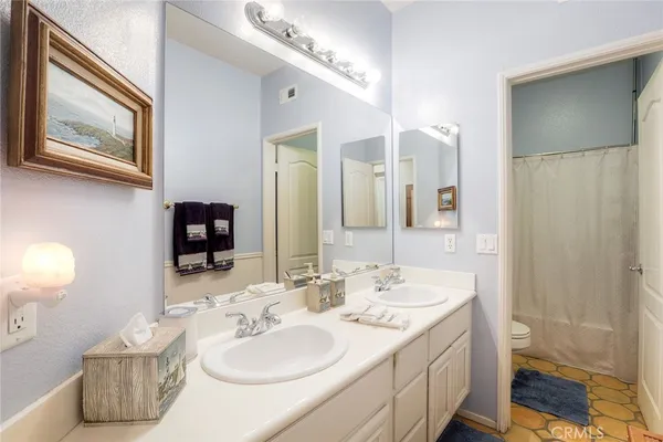 a bathroom with a sink double vanity and a mirror