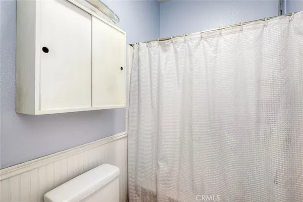 a bathroom with a shower curtain and a sink