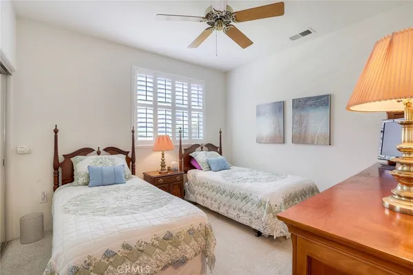 a bedroom with two bed and a table