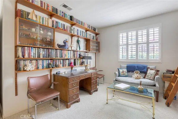 a work room with furniture and a book shelf